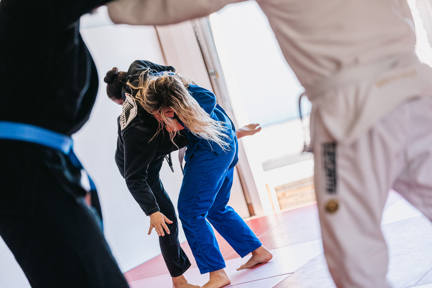 Students practicing BJJ techniques
